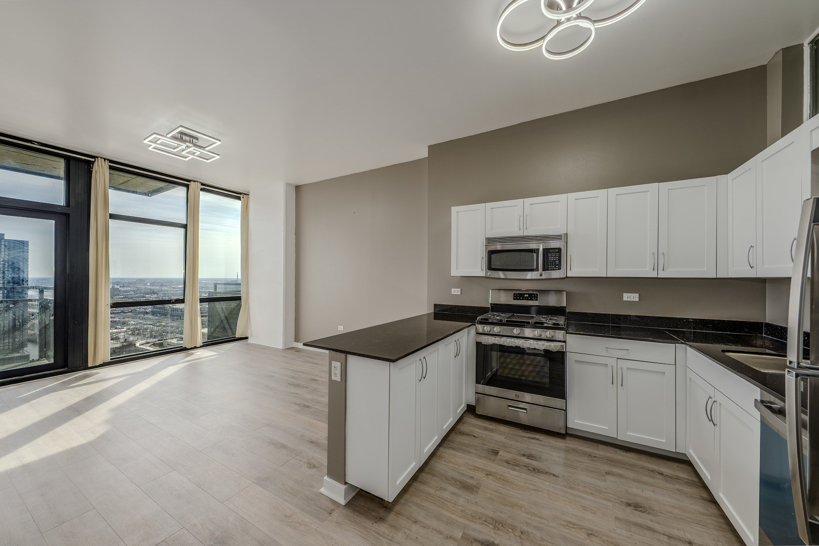 235 West Van Buren Street, Unit 3105 Chicago, IL 60607 - Photo 6 of 29 a kitchen with stainless steel appliances granite countertop a stove and a sink