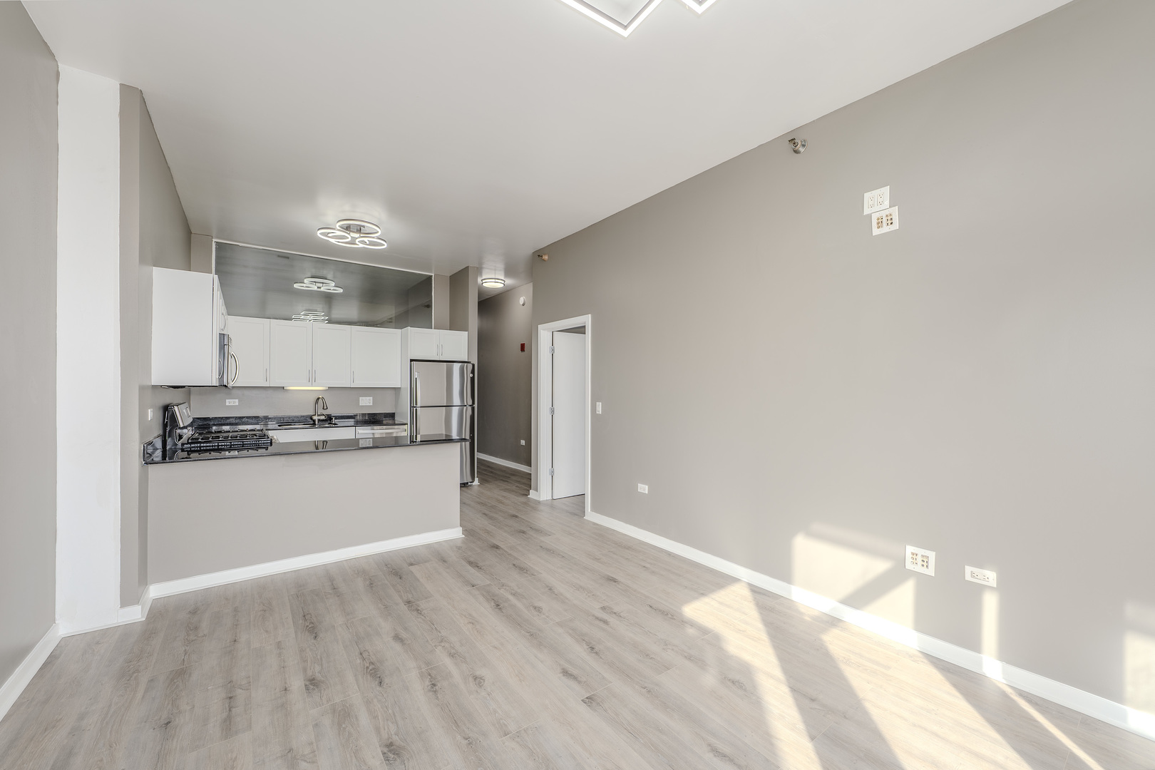 235 West Van Buren Street, Unit 3105 Chicago, IL 60607 - Photo 7 of 29 a kitchen with a refrigerator and white cabinets
