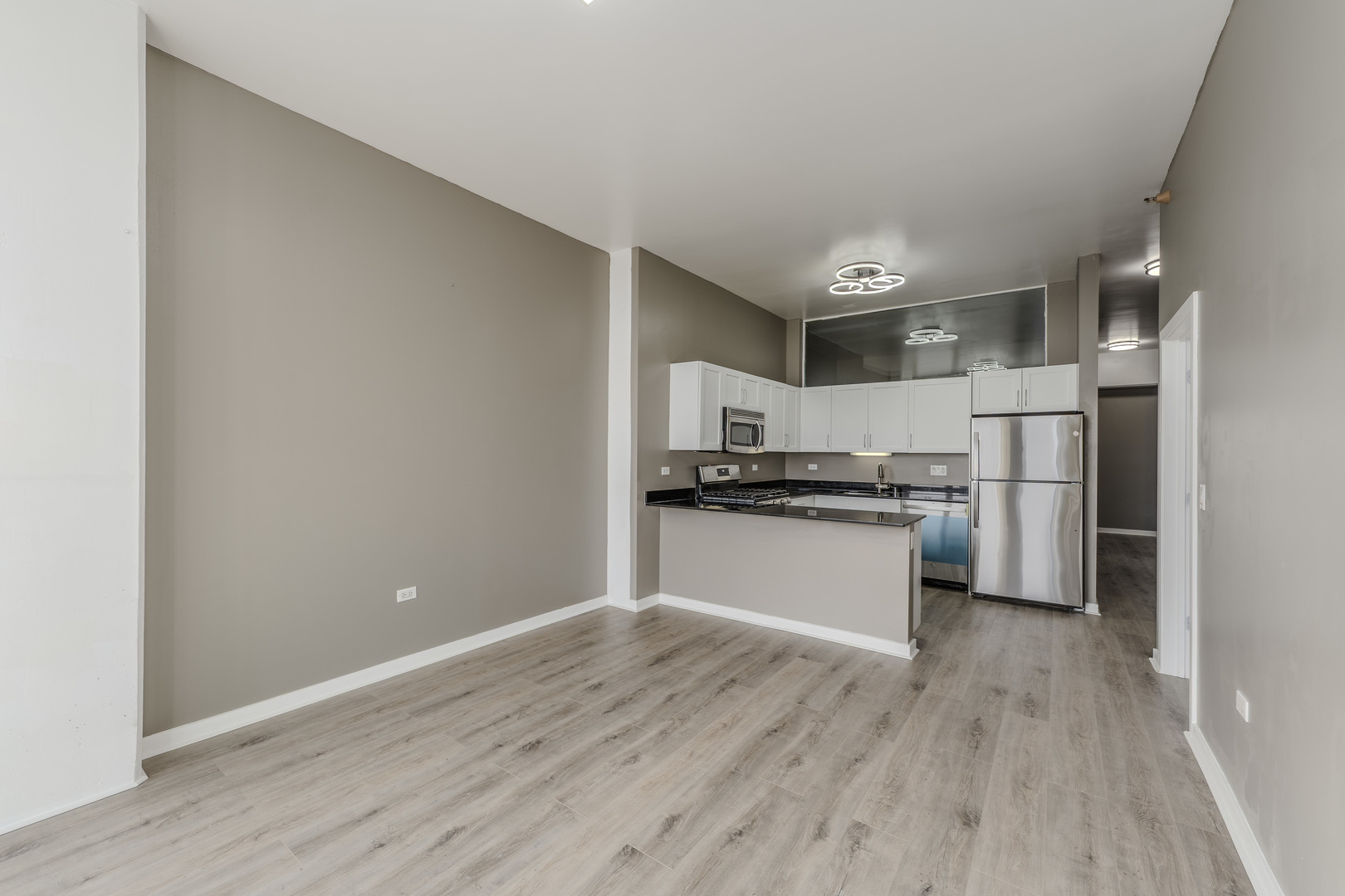 235 West Van Buren Street, Unit 3105 Chicago, IL 60607 - Photo 8 of 29 a kitchen with a refrigerator and white cabinets