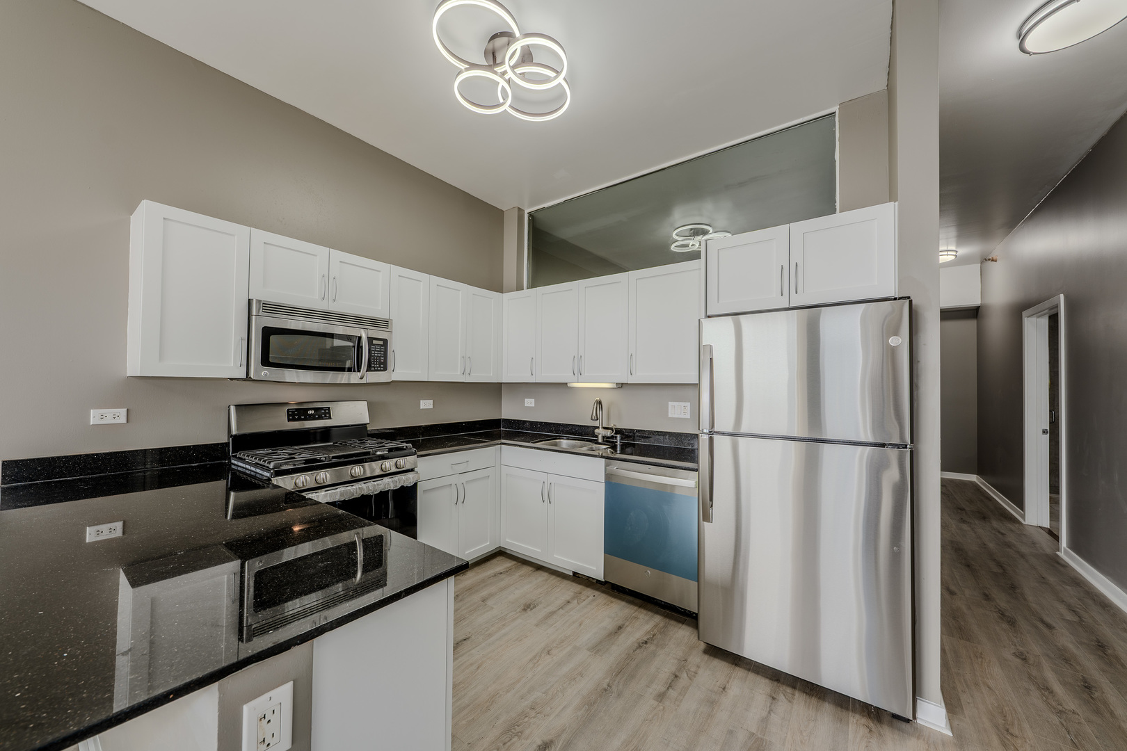 235 West Van Buren Street, Unit 3105 Chicago, IL 60607 - Photo 9 of 29 a kitchen with stainless steel appliances a refrigerator sink and microwave