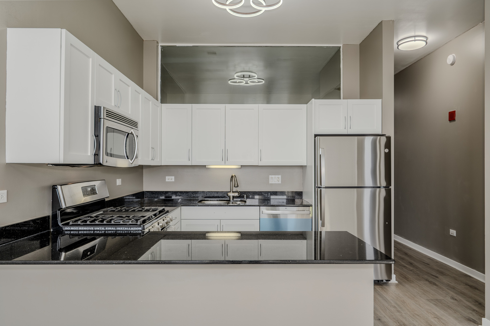 235 West Van Buren Street, Unit 3105 Chicago, IL 60607 - Photo 10 of 29 a kitchen with a refrigerator a stove a microwave and cabinets