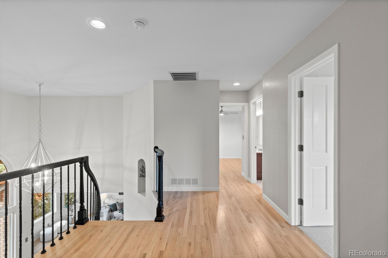 3900 Pierson Street Wheat Ridge, CO 80033 - Photo 19 of 39 a view of a hallway with wooden floor and staircase