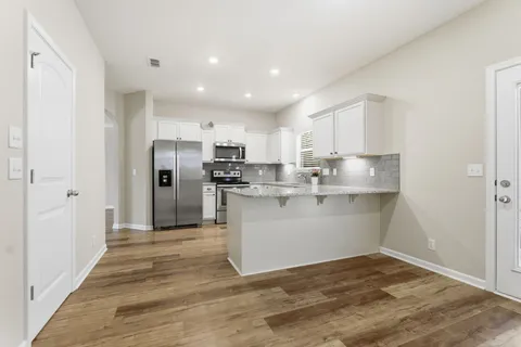 a view of kitchen with wooden floor
