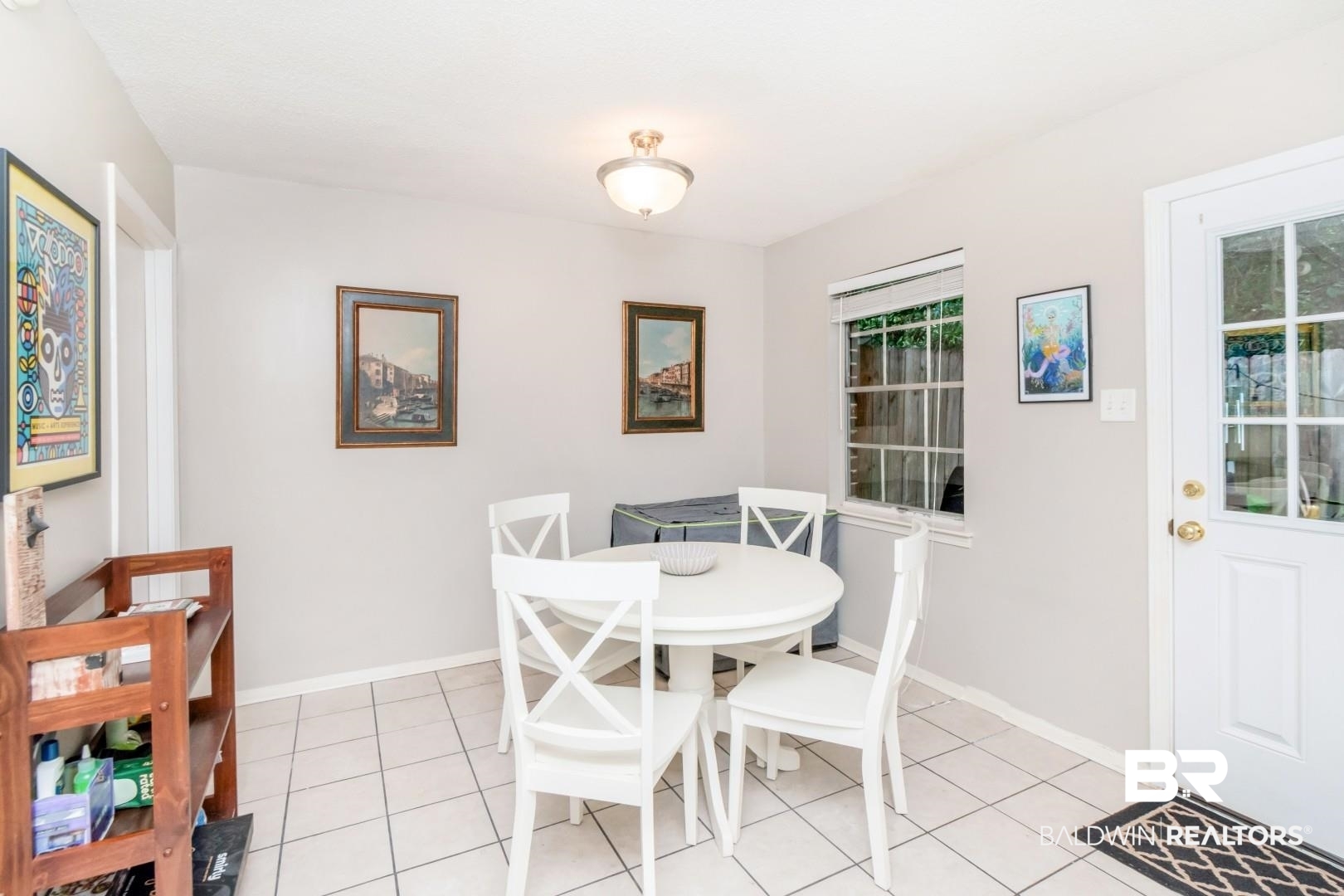 118 Du Rhu Drive, Unit H Mobile, AL 36608 - Photo 9 of 19 Dining area featuring ceramic tile flooring, a window with exterior visibility, a ceiling-mounted light fixture, and a glass-paneled exterior door