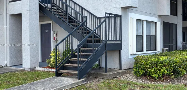 a view of front door and porch with wooden floor