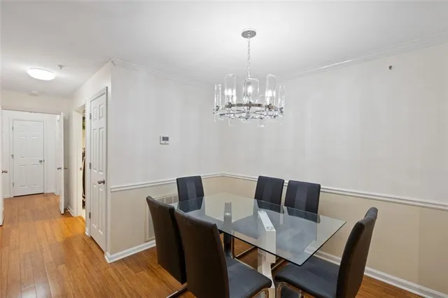 a view of a dining room with furniture wooden floor and chandelier