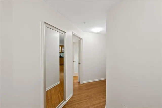 a view of hallway with wooden floor