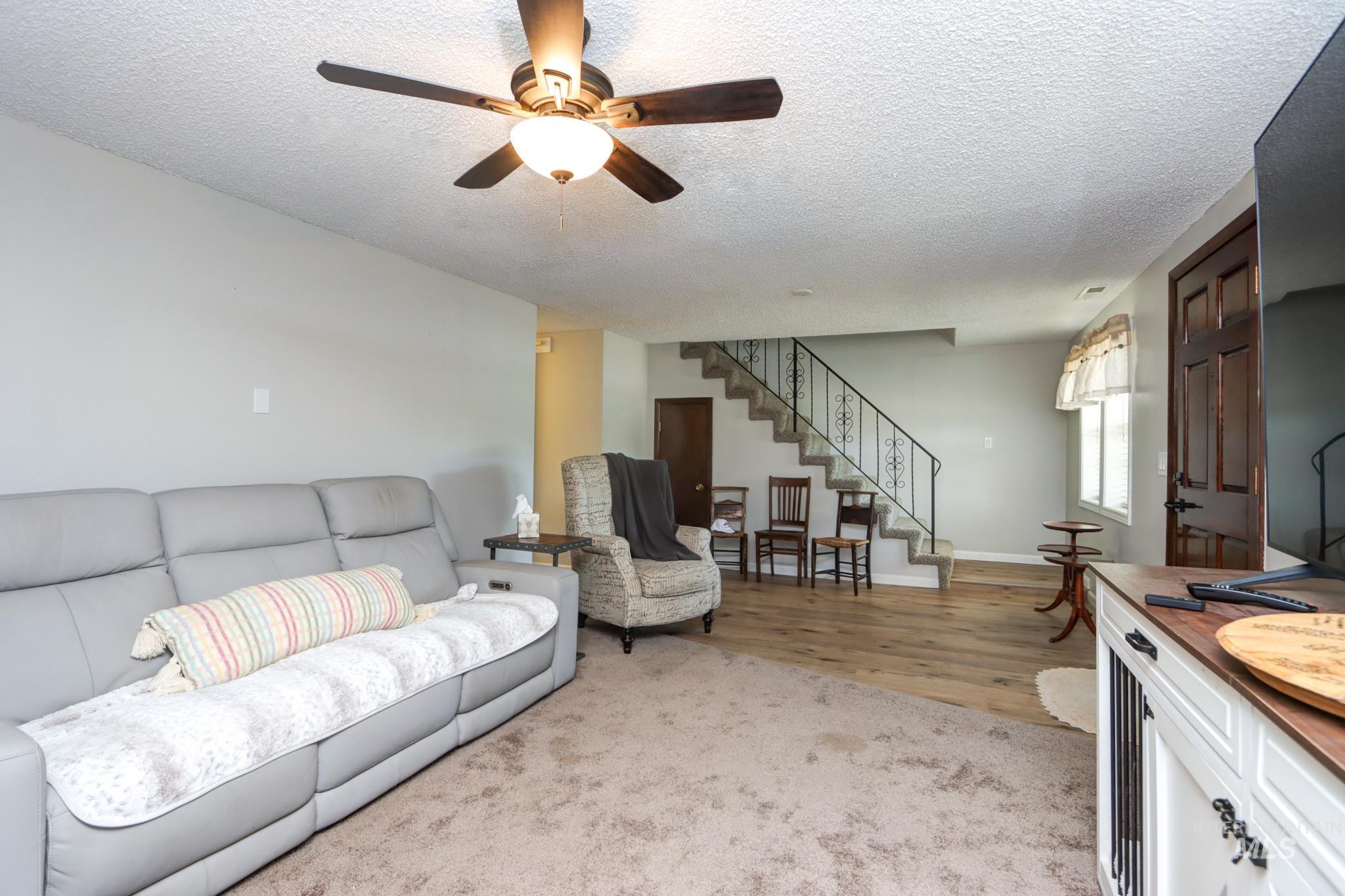 2528 Waterwheel Road Emmett, ID 83617 - Photo 16 of 50 The living area features light wood-finish flooring at the entry, transitioning to plush carpeting