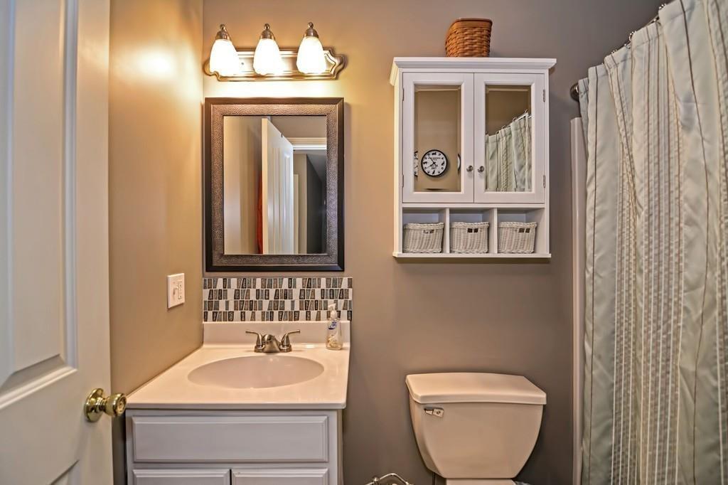 774 Reed Street Warren, MA 01092 - Photo 33 of 42 a bathroom with a toilet sink and mirror