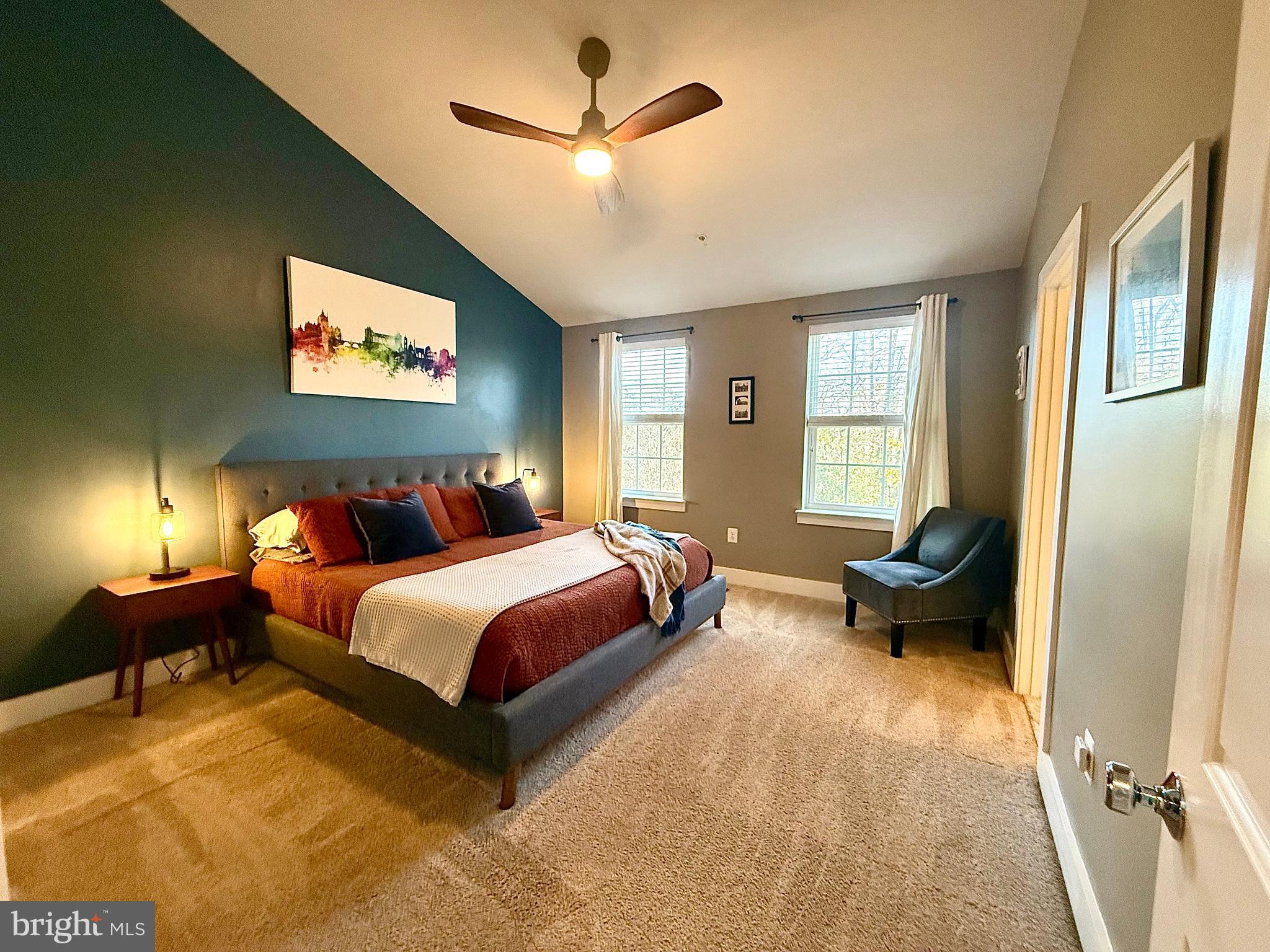120 Waterline Court Annapolis, MD 21401 - Photo 28 of 38 a spacious bedroom with a bed and a chandelier