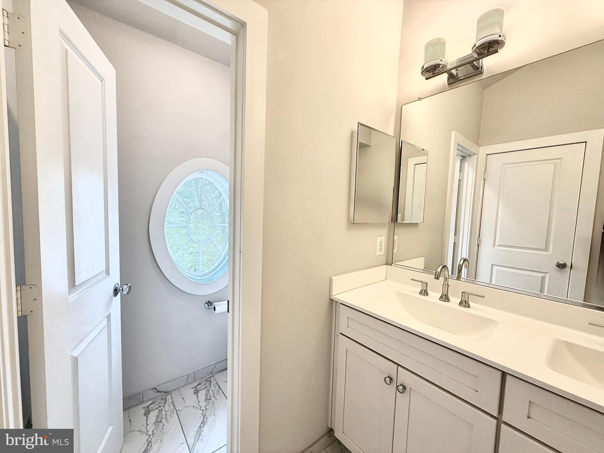 120 Waterline Court Annapolis, MD 21401 - Photo 32 of 38 a bathroom with a sink and a mirror