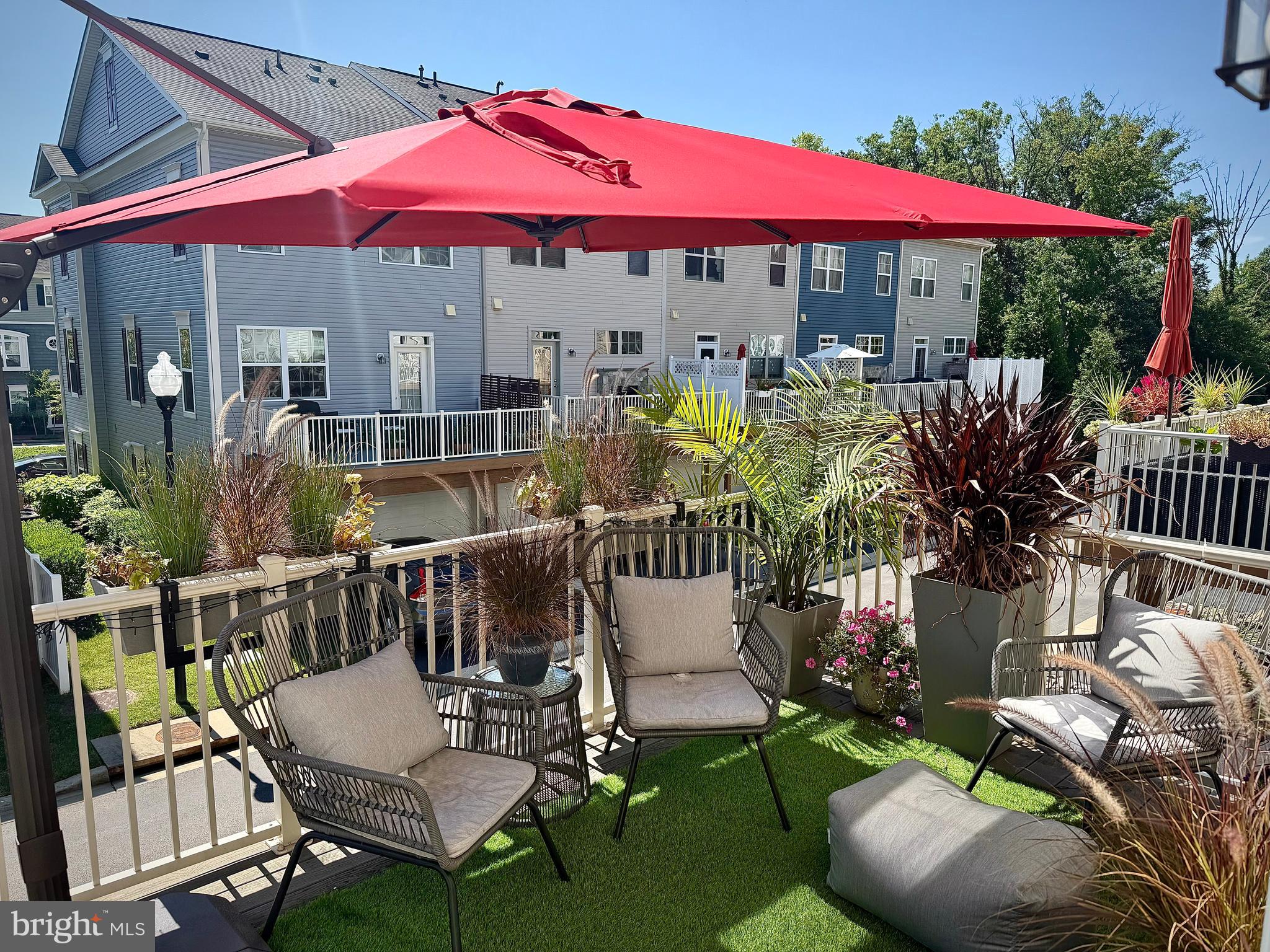 120 Waterline Court Annapolis, MD 21401 - Photo 34 of 38 a patio with tables and chairs a fire pit and two lawn chairs