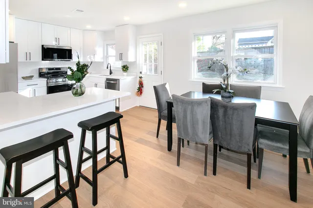 a view of a dining room with furniture and a window