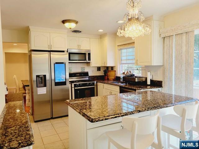 144 Valley Road Haworth, NJ 07641 - Photo 5 of 14 a kitchen with stainless steel appliances granite countertop a sink refrigerator and microwave