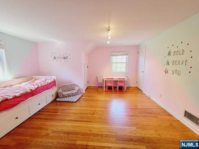 144 Valley Road Haworth, NJ 07641 - Photo 9 of 14 a bedroom with a bed and wooden floor