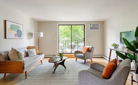 a living room with furniture and a window