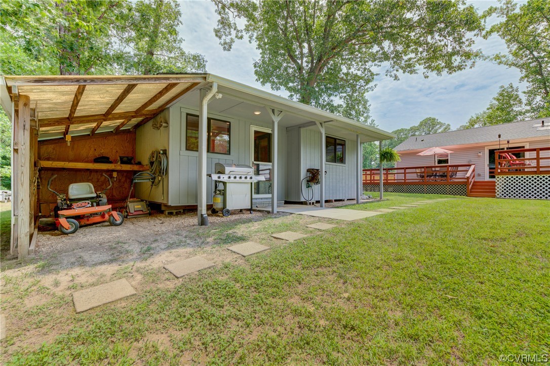 382 Hideaway Point Road Topping, VA 23169 - Photo 12 of 50 a view of a house with a big yard and sitting area