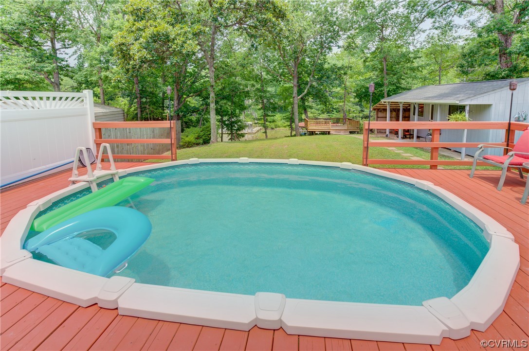 382 Hideaway Point Road Topping, VA 23169 - Photo 18 of 50 a view of a swimming pool with a deck