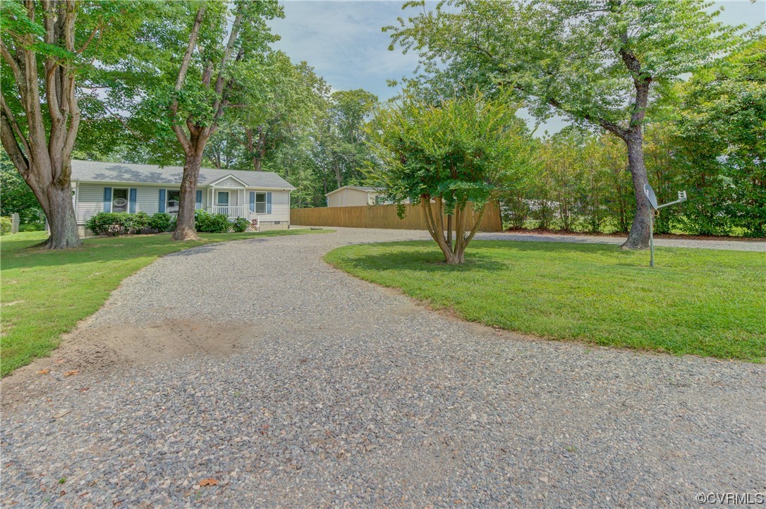 382 Hideaway Point Road Topping, VA 23169 - Photo 2 of 50 a front view of a house with a yard