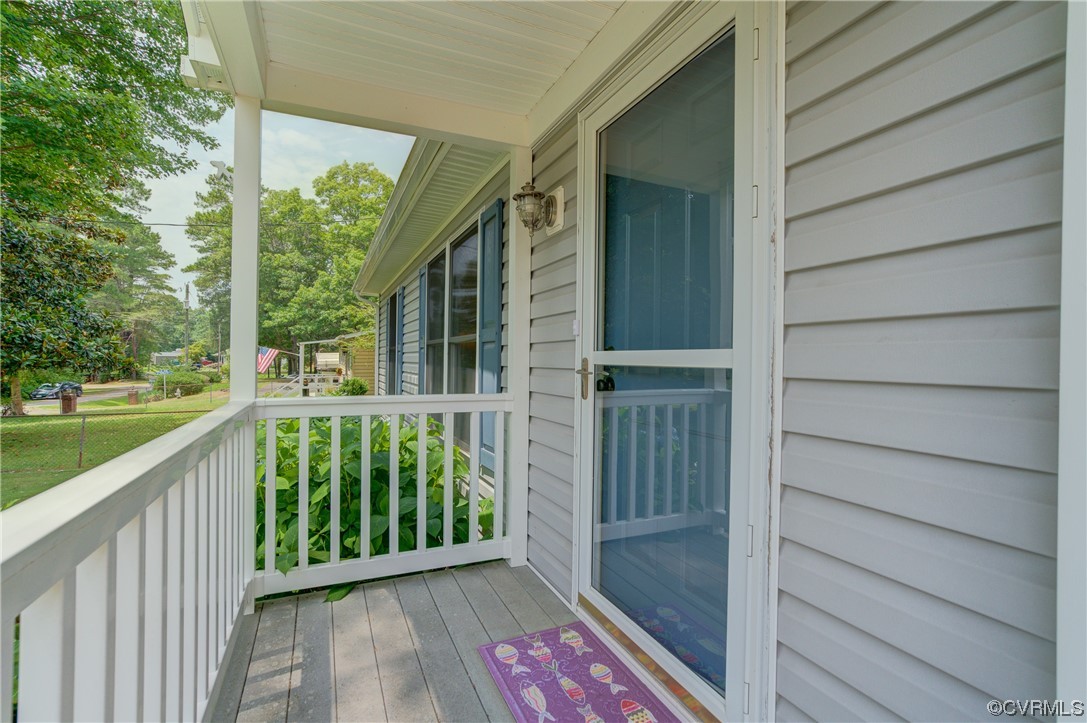 382 Hideaway Point Road Topping, VA 23169 - Photo 21 of 50 a view of a porch with wooden floor and outdoor space