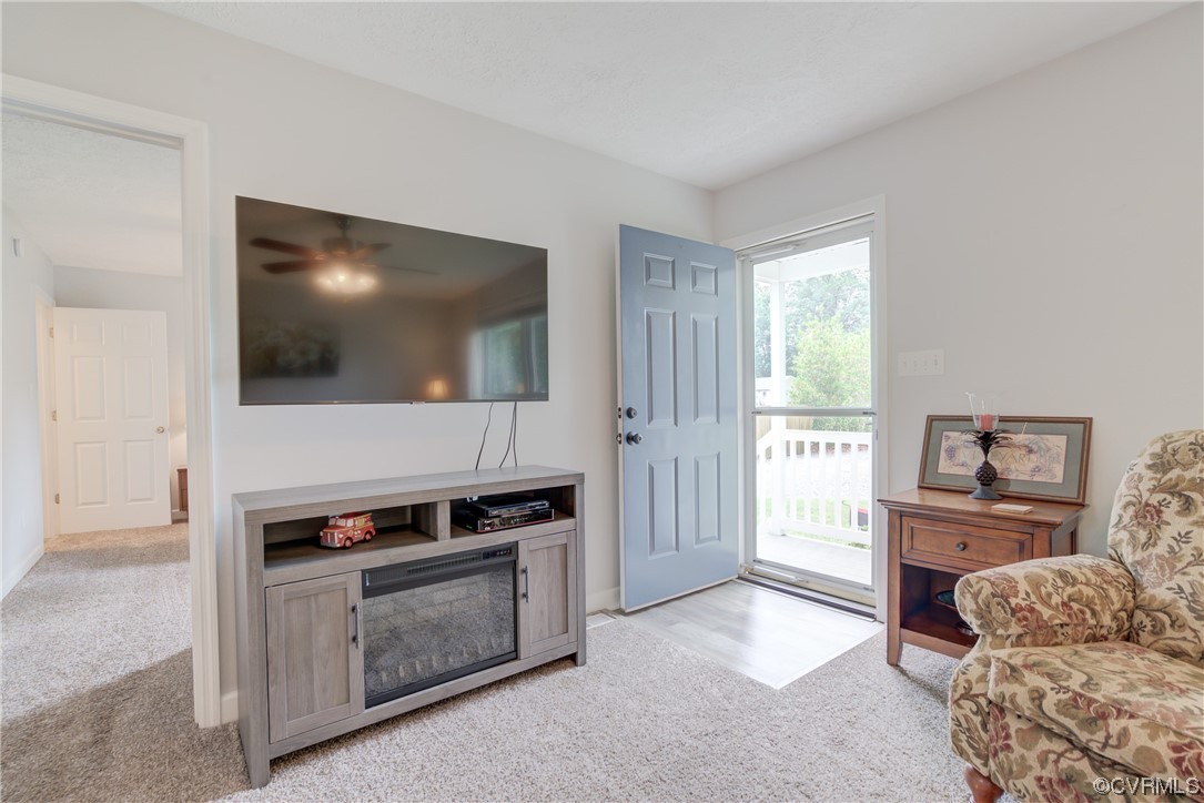 382 Hideaway Point Road Topping, VA 23169 - Photo 23 of 50 a living room with furniture and a flat screen tv