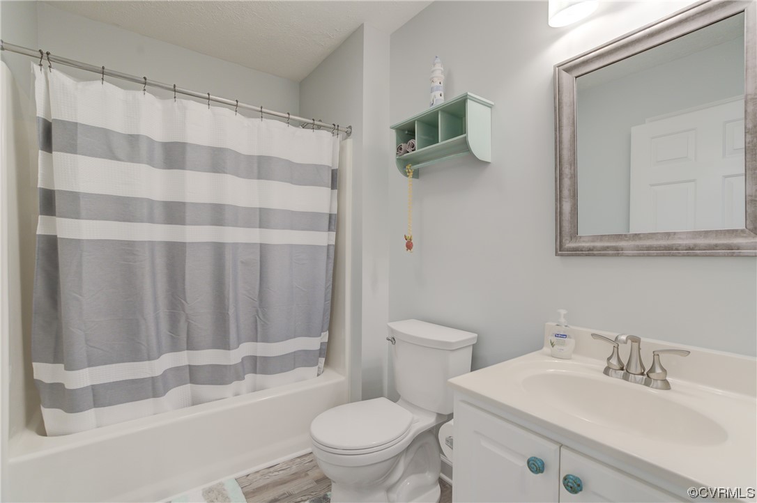 382 Hideaway Point Road Topping, VA 23169 - Photo 25 of 50 a bathroom with a sink toilet and shower