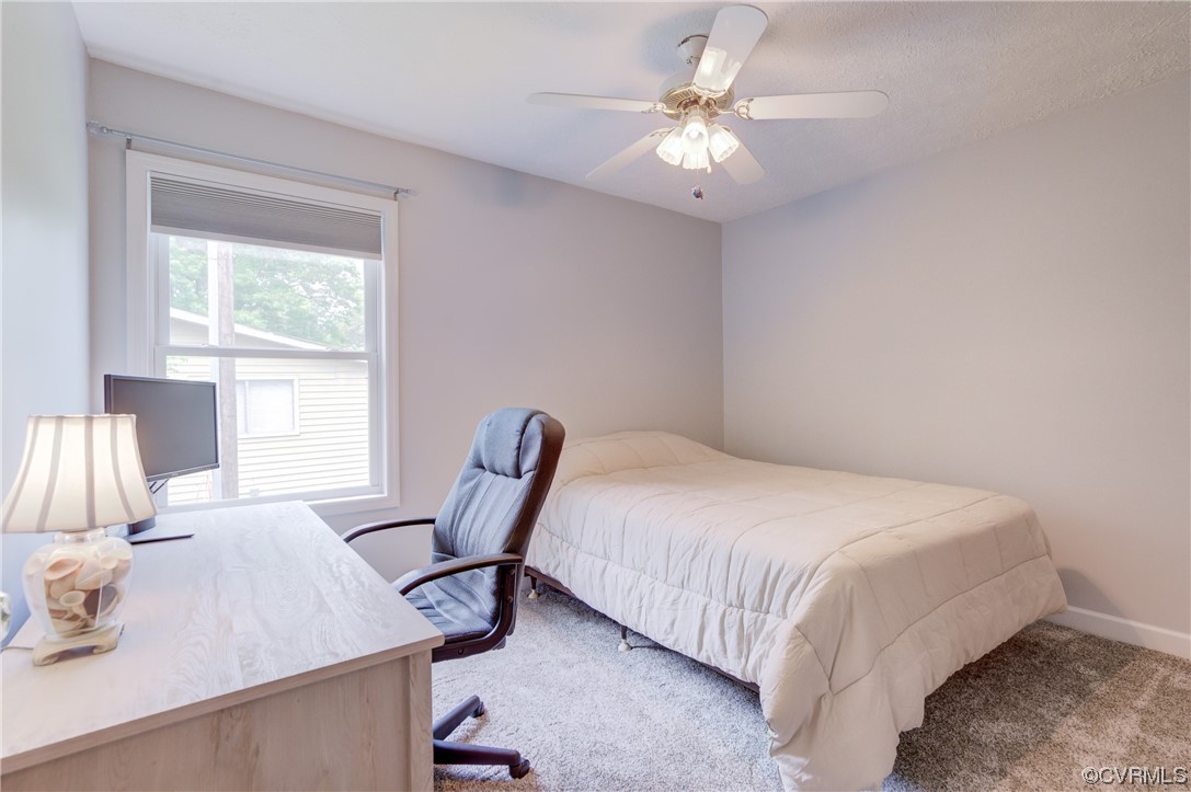 382 Hideaway Point Road Topping, VA 23169 - Photo 27 of 50 a bedroom with a bed a desk and chair
