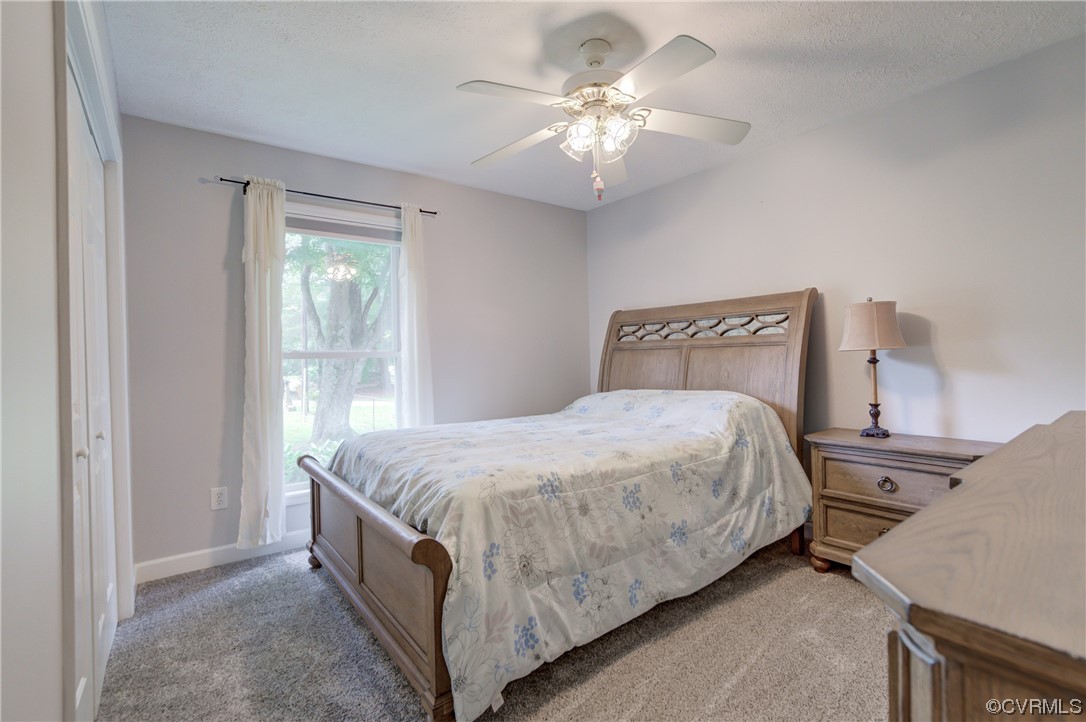 382 Hideaway Point Road Topping, VA 23169 - Photo 28 of 50 a bed sitting in a bedroom next to a window