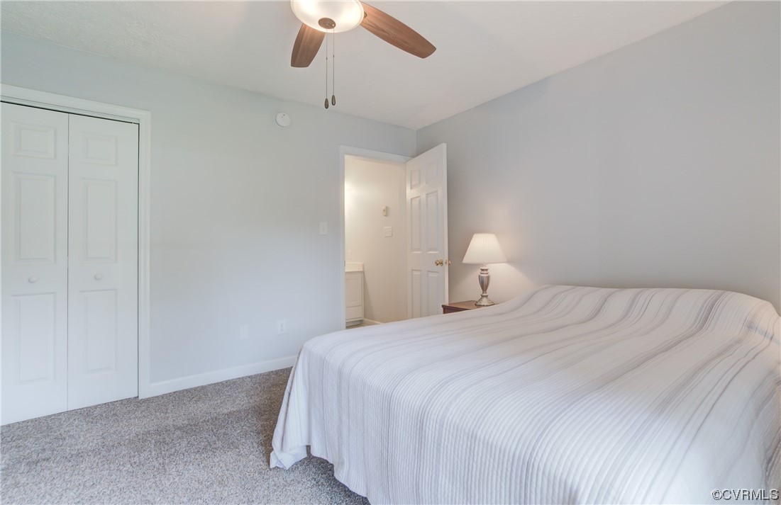 382 Hideaway Point Road Topping, VA 23169 - Photo 30 of 50 a bedroom with a bed and a lamp