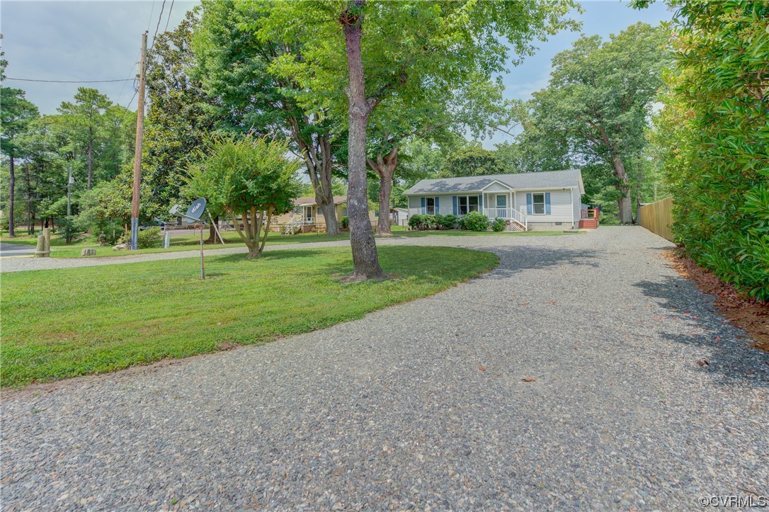 382 Hideaway Point Road Topping, VA 23169 - Photo 3 of 50 a front view of a house with yard and green space