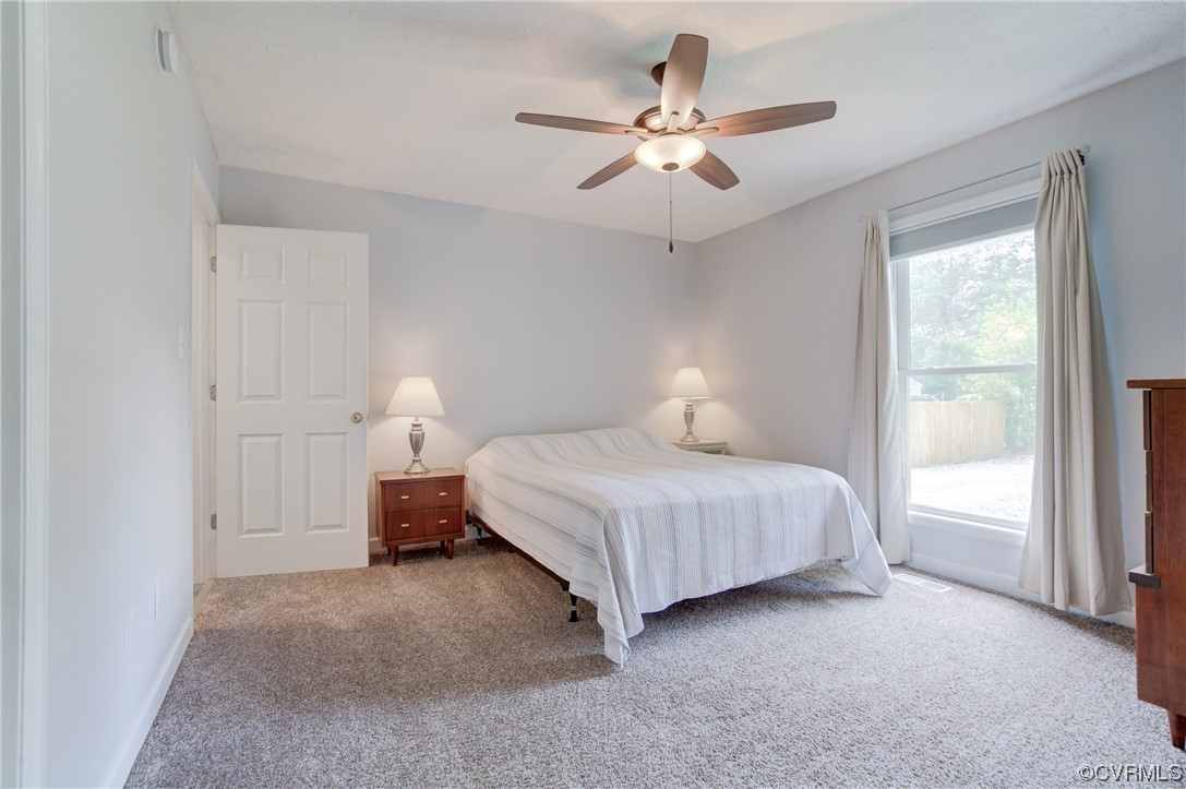 382 Hideaway Point Road Topping, VA 23169 - Photo 31 of 50 a bedroom with a bed and a window
