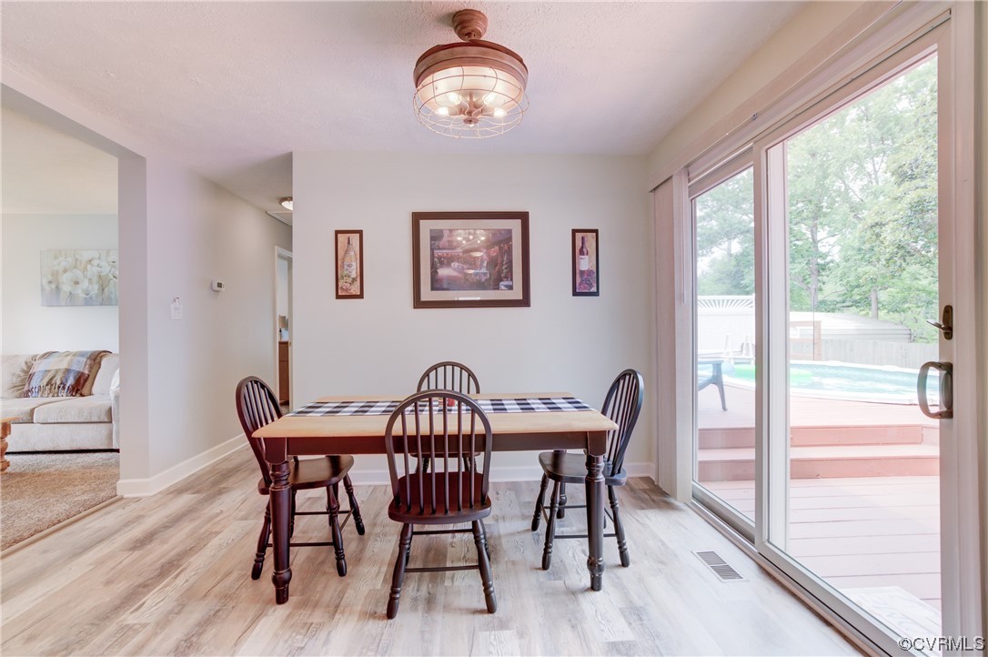382 Hideaway Point Road Topping, VA 23169 - Photo 36 of 50 a view of a dining room with furniture window and wooden floor