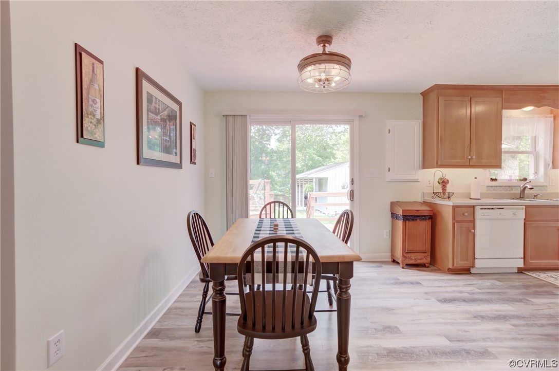 382 Hideaway Point Road Topping, VA 23169 - Photo 37 of 50 a view of a dining room with furniture window and wooden floor