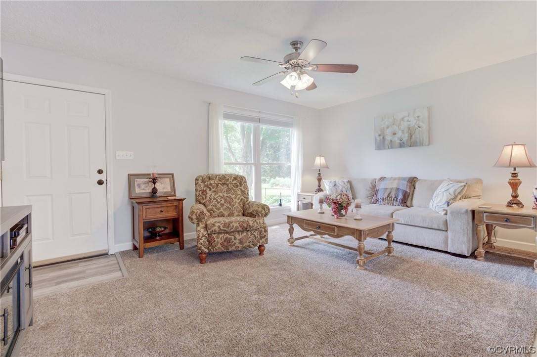 382 Hideaway Point Road Topping, VA 23169 - Photo 39 of 50 a living room with furniture and lamp