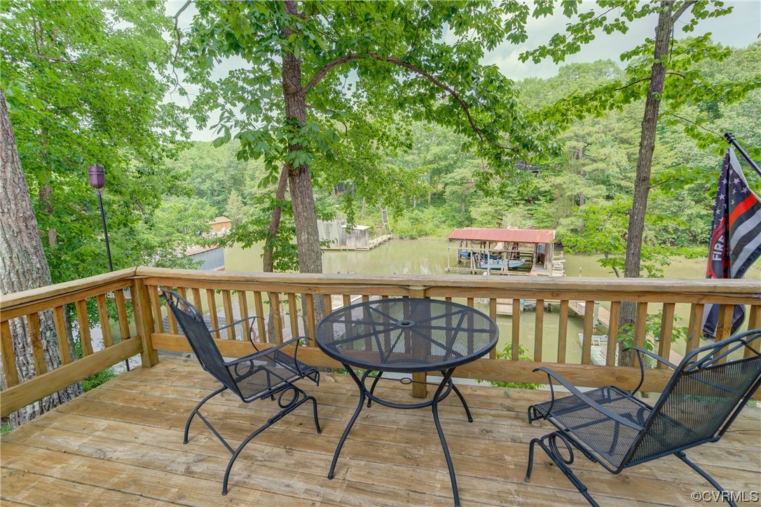 382 Hideaway Point Road Topping, VA 23169 - Photo 6 of 50 a view of a chairs and table in the balcony