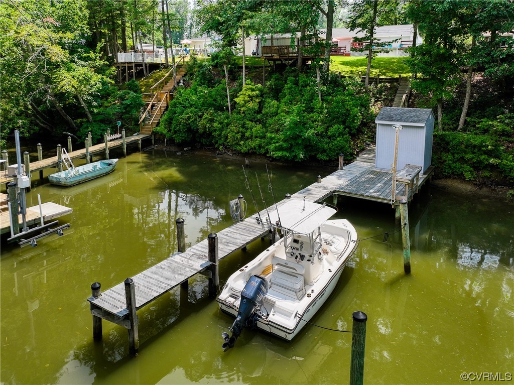 382 Hideaway Point Road Topping, VA 23169 - Photo 9 of 50 an aerial view of a house with swimming pool and lake view