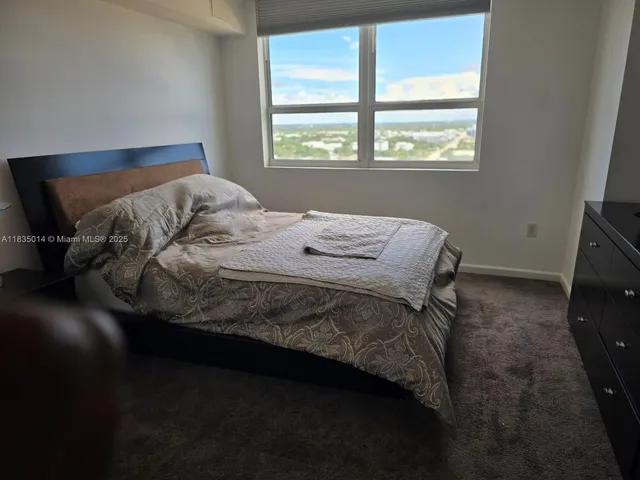 a bed sitting in a bedroom next to a shower