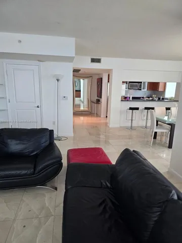 a living room with furniture and a lamp