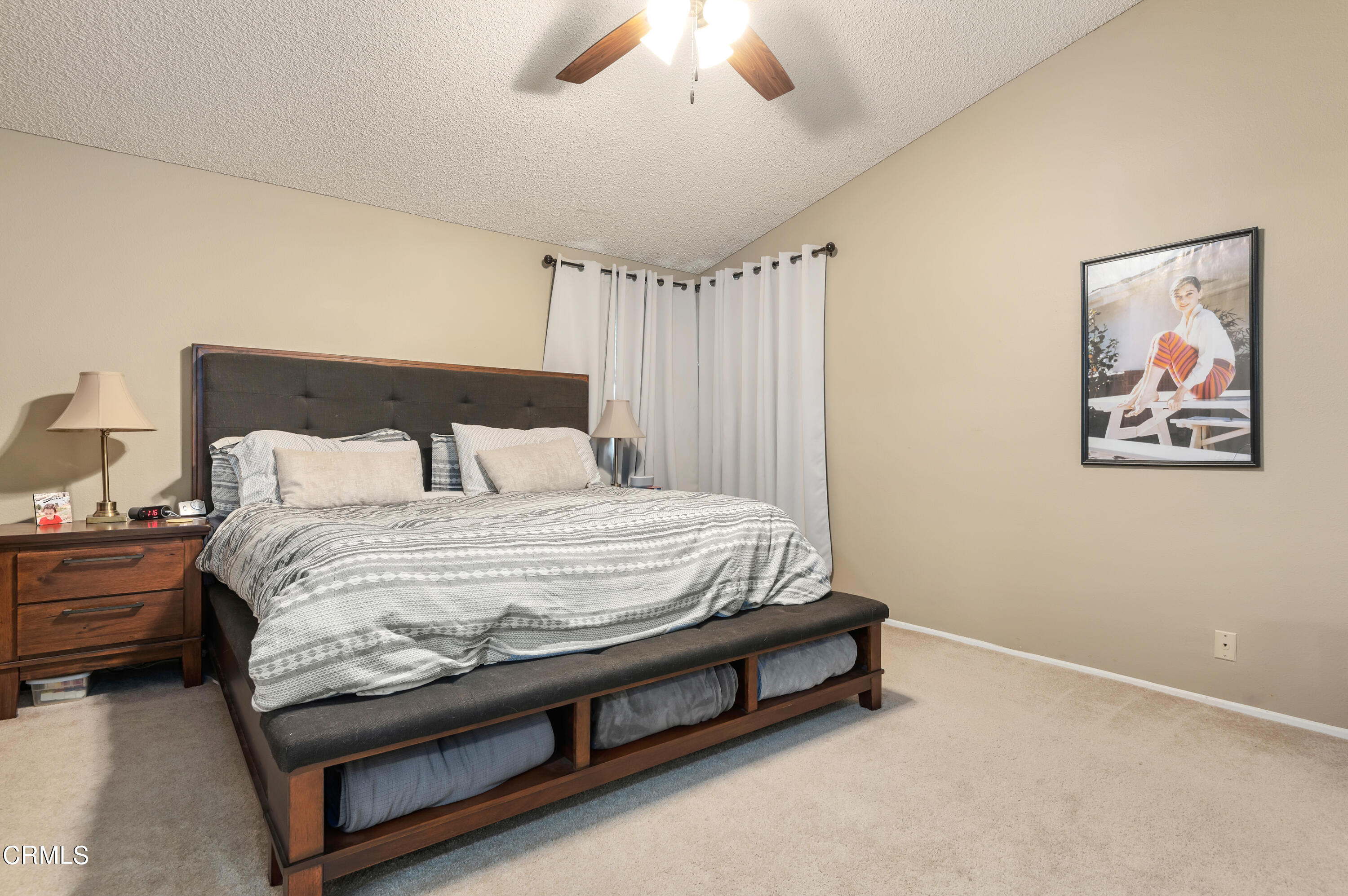 3550 Olds Road Oxnard, CA 93033 - Photo 15 of 26 a bedroom with a bed and a chandelier