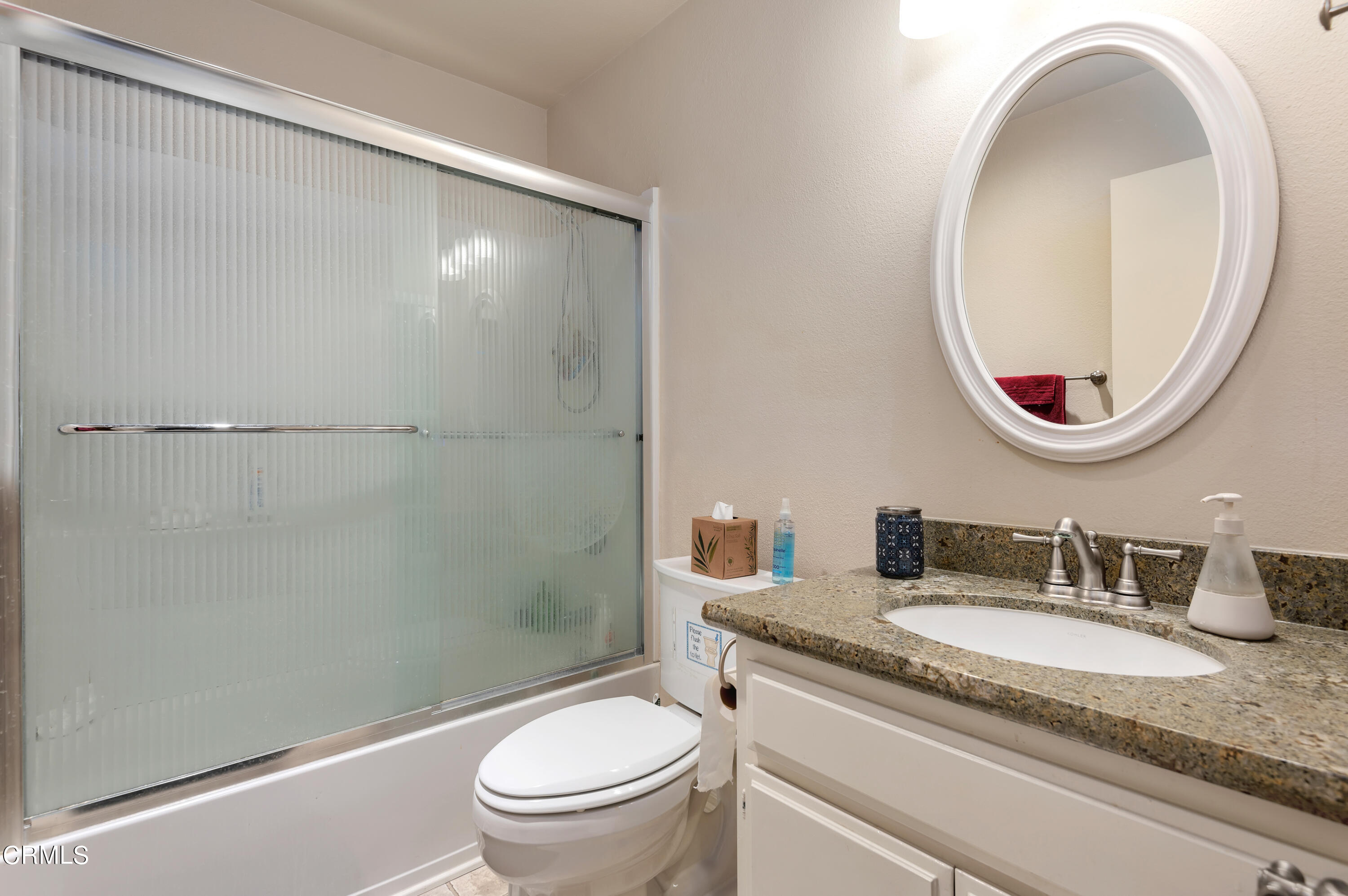 3550 Olds Road Oxnard, CA 93033 - Photo 19 of 26 a bathroom with a granite countertop sink toilet mirror and a shower