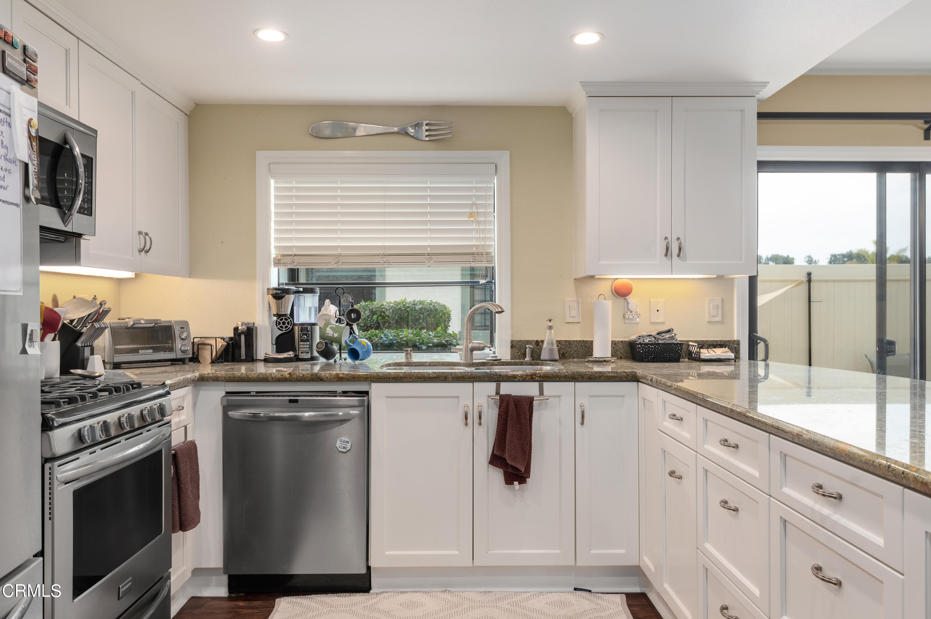 3550 Olds Road Oxnard, CA 93033 - Photo 8 of 26 a kitchen with a sink stove and cabinets