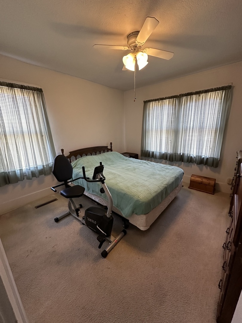 25 North Walnut Street Tamaroa, IL 62888 - Photo 6 of 18 a bedroom with a bed and a chandelier