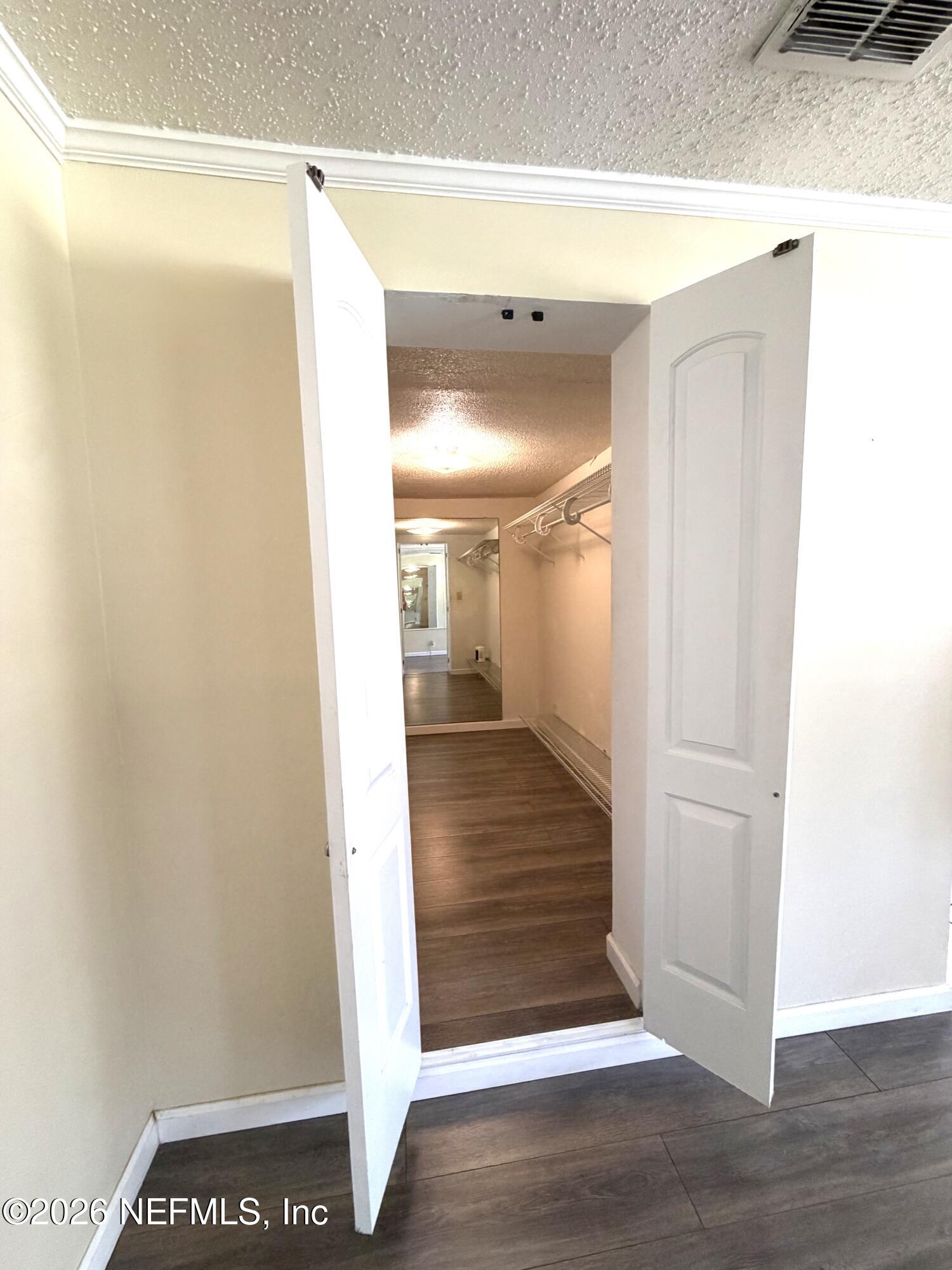 4127 Springwood Road Jacksonville, FL 32207 - Photo 19 of 63 a view of a hallway with wooden floor