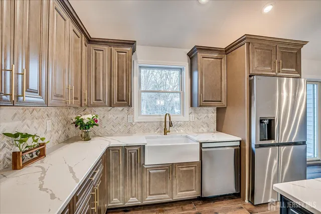 a kitchen with stainless steel appliances granite countertop a sink stove and refrigerator