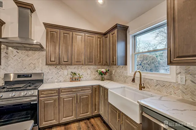 a kitchen with a sink stove and cabinets