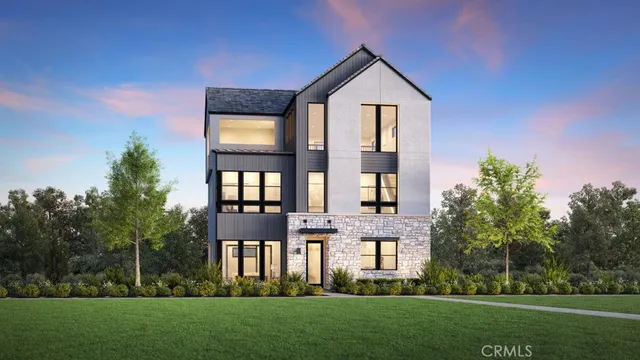 a front view of a house with a yard and trees