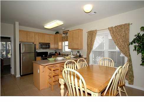 228 Hidden Lake Way Santa Rosa Beach, FL 32459 - Photo 3 of 11 a kitchen with sink refrigerator and microwave
