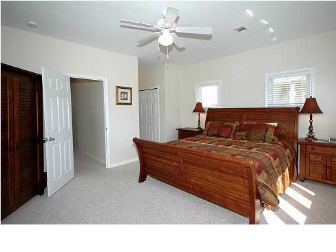 228 Hidden Lake Way Santa Rosa Beach, FL 32459 - Photo 5 of 11 a bedroom with a bed and a chandelier