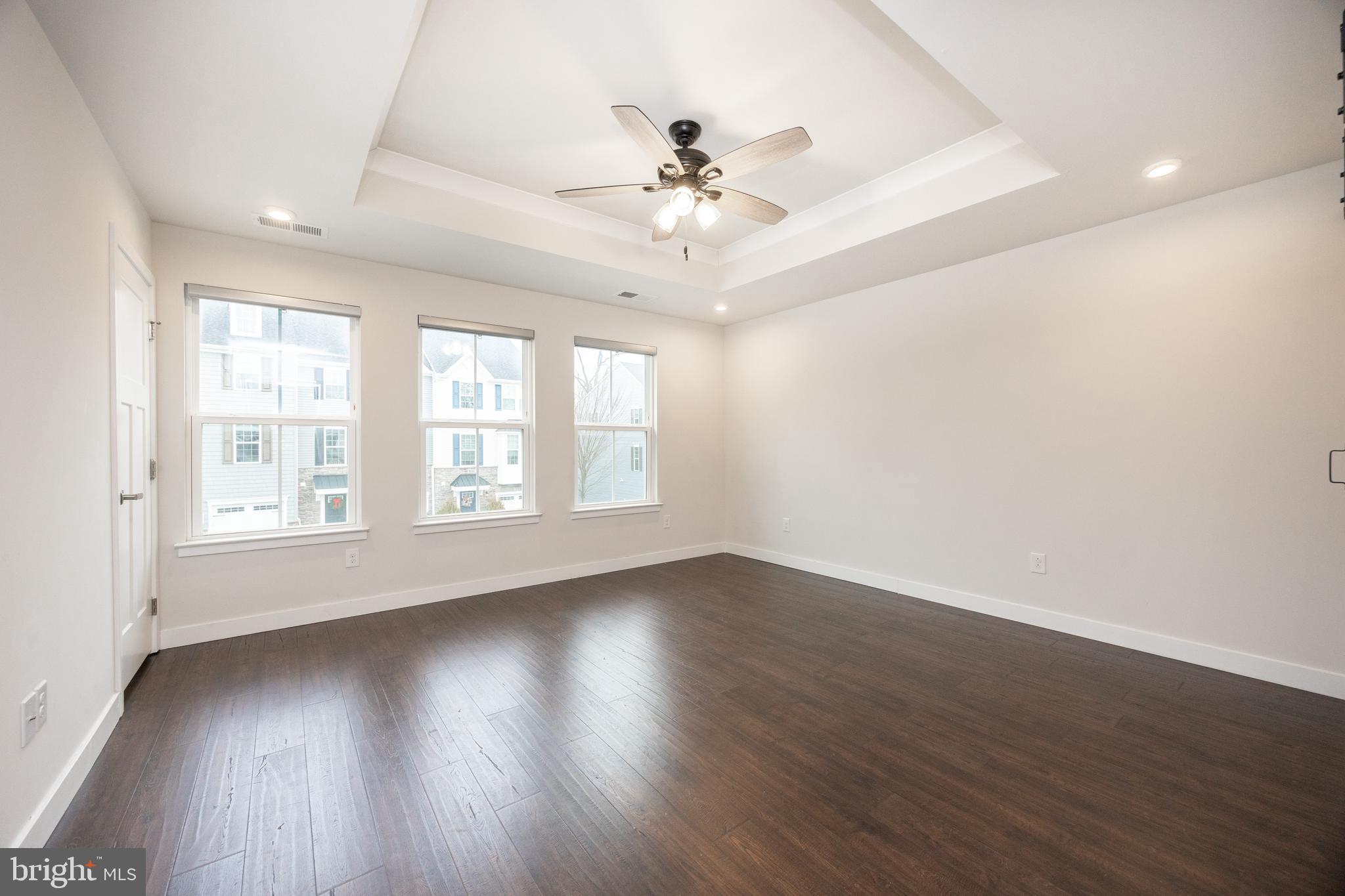 131 Mulberry Drive Malvern, PA 19355 - Photo 14 of 37 an empty room with wooden floor chandelier fan and windows