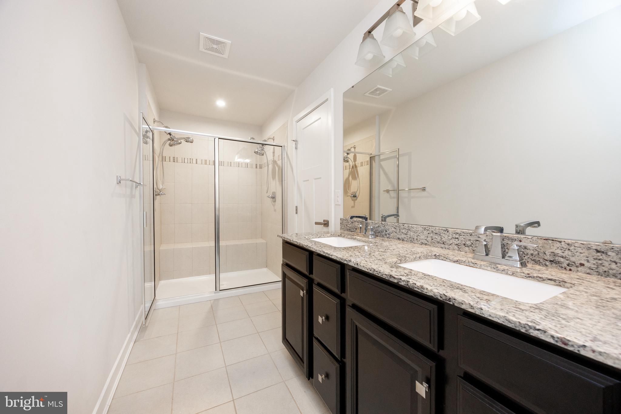 131 Mulberry Drive Malvern, PA 19355 - Photo 18 of 37 a bathroom with a granite countertop sink a mirror and a shower